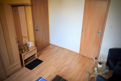 a living room with a door and a wooden floor at Ubytovani Nikol in Brno