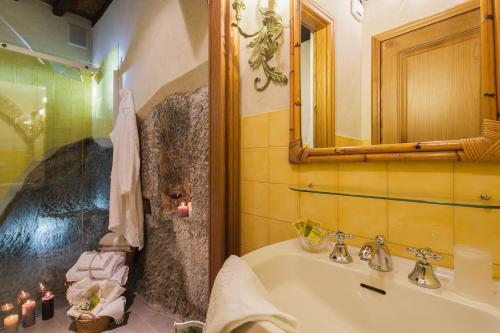 a bathroom with a tub and a sink and a mirror at Belvedere in Cortona
