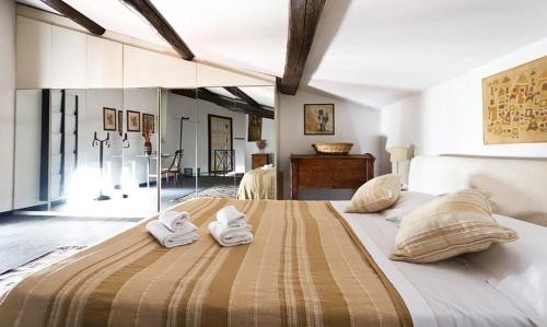 a bedroom with a large bed with towels on it at Appartamento Coronari in Rome