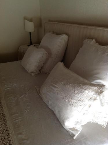 a bed with white sheets and pillows on it at Le Case Di San Vitale in Ravenna