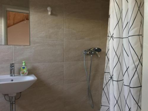 a bathroom with a shower and a sink at Residencial Avenida Hostel in Tomar
