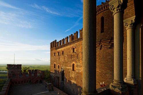 a large brick building with a view of the horizon at Castello di Gabiano in Gabiano
