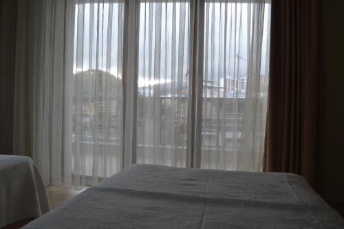 a bedroom with a bed and a large window at Almasa Suite Aparts in Termal
