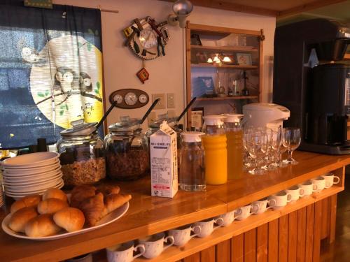 a counter with a bunch of food on it at Pension Locomotion in Kutchan
