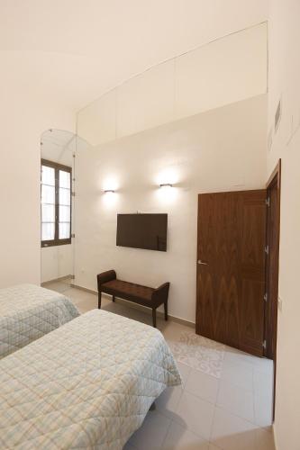 Postel nebo postele na pokoji v ubytování Palacio Muñoz Chaves Cáceres