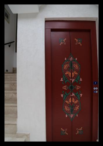 a red door with a design on it at Dar Souran in Tangier