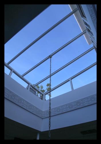 a window in a building with a chain at Dar Souran in Tangier