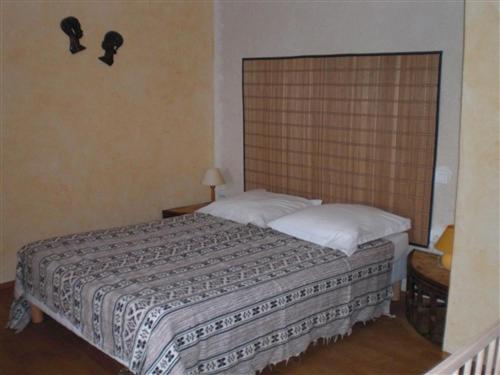 a bedroom with a large bed with two pillows at chambres d'hôtes de la colline in Chenay-le-Châtel