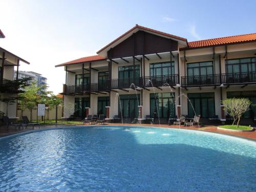 a swimming pool in front of a building at Espira Kinrara in Puchong