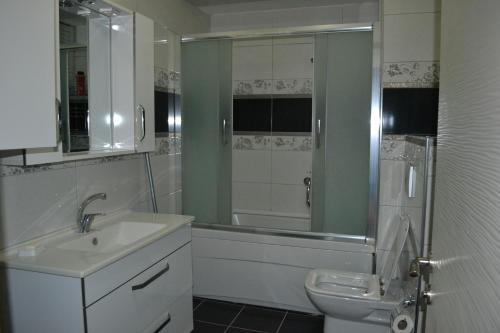 a bathroom with a sink and a toilet and a shower at Almasa Suite Aparts in Termal