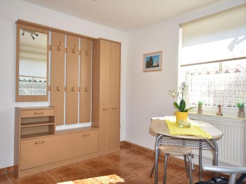 a kitchen with a table and a cupboard at Modern Bungalow in Kr pelin with Garden in Kröpelin