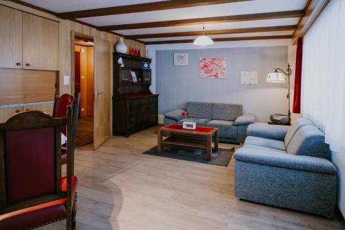 a living room with a couch and a table at Chalet Aloa in Adelboden