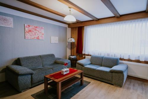 a living room with two couches and a coffee table at Chalet Aloa in Adelboden