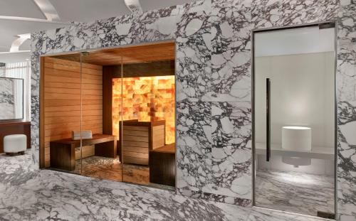 a bathroom with a mirror on a wall at The Reverie Saigon Residential Suites in Ho Chi Minh City