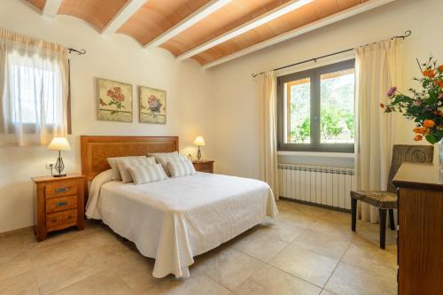 a bedroom with a bed and a window at Villa Luna in Sant Joan de Labritja