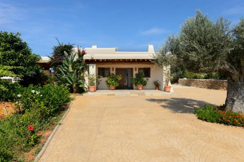 a house with a walkway in front of it at Villa Luna in Sant Joan de Labritja