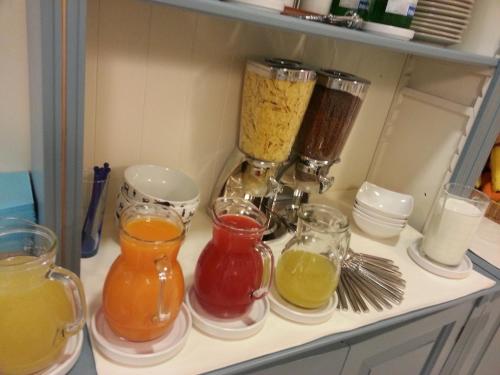a kitchen counter with four different types of juice at Hotel Il Gatto in Rapallo