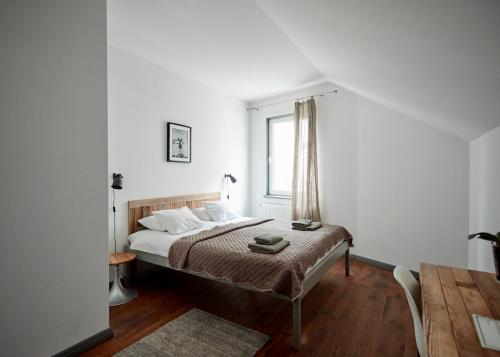 a bedroom with a bed and a window at 2 Baloži in Kuldīga
