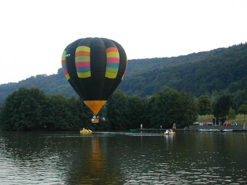 a hot air balloon flying over a body of water at Mesón de la Molinera in Arcos de la Frontera