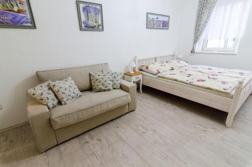 a living room with a couch and a bed at Guesthouse SaM in Roudnice nad Labem