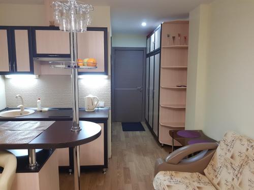 a kitchen with a table and a dining room at New Gudauri Sunny studio in Gudauri
