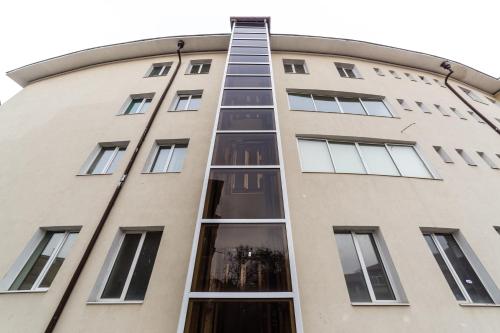 a building with a ladder on the side of it at Семеен хотел Пауталия in Kyustendil