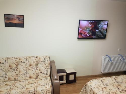 a bedroom with two beds and a tv on the wall at New Gudauri Sunny studio in Gudauri