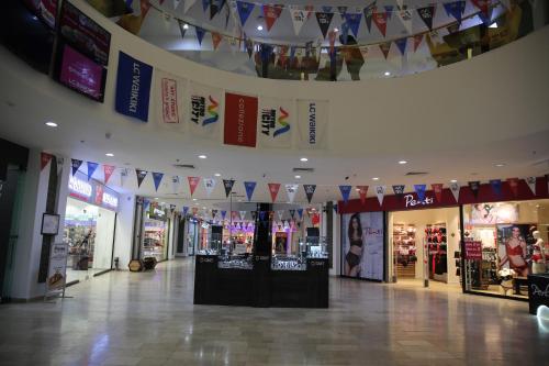 a shopping mall with flags hanging from the ceiling at Euphoria Apartments in Batumi