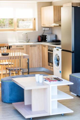 a kitchen with a table and a refrigerator at Summer Villas Crete in Balíon