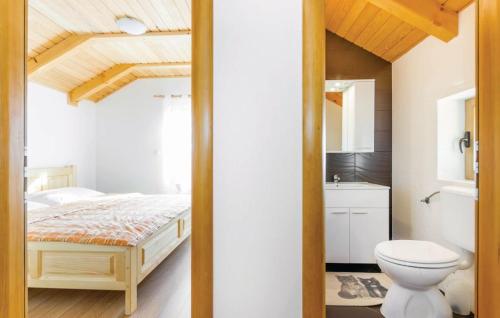 a bathroom with a bed and a toilet in a room at Villa Mila in Sveti Juraj