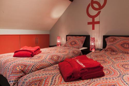 two beds sitting next to each other in a room at La Renaissance 1&2 high standing guest house in Herve