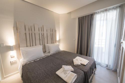 a hotel room with a bed with towels on it at Crystal Waters in Nikiana