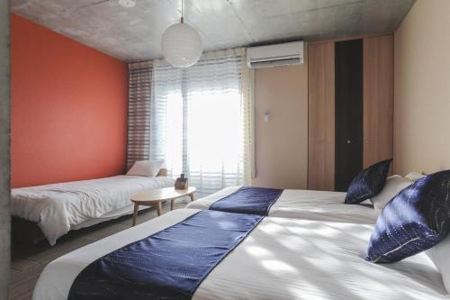 Un pat sau paturi într-o cameră la Naganoya
