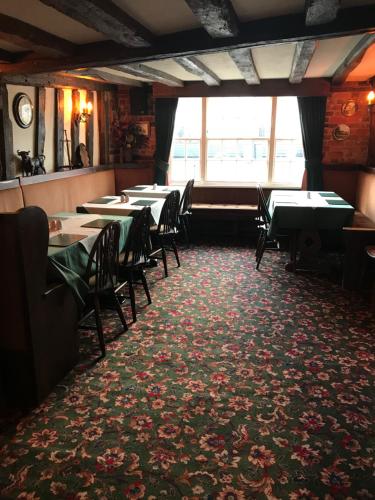 a row of tables and chairs in a restaurant at The Black Bull Inn in Fyfield