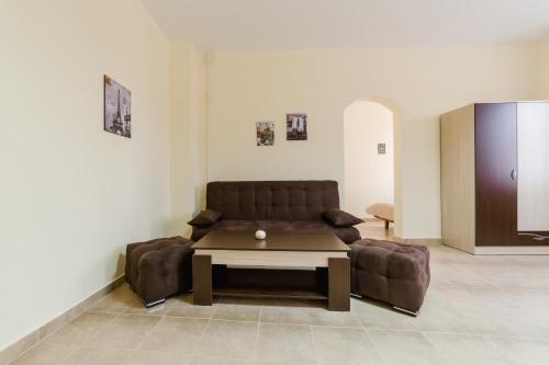 a living room with a couch and a table at Семеен хотел Пауталия in Kyustendil