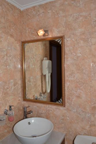 a bathroom with a sink and a mirror at Pension Anapli in Nafplio