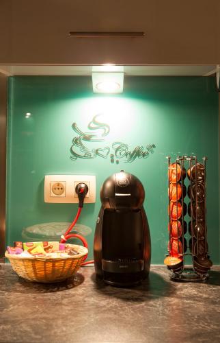 a coffee maker on a counter next to a basket of food at La Renaissance 1&2 high standing guest house in Herve