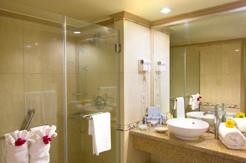 a bathroom with a shower and a sink and a mirror at Breezes Resort & Spa All Inclusive, Bahamas in Nassau