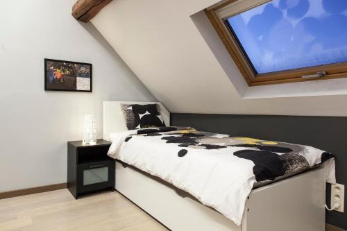 a bedroom with a bed and a large screen at La Renaissance 1&2 high standing guest house in Herve
