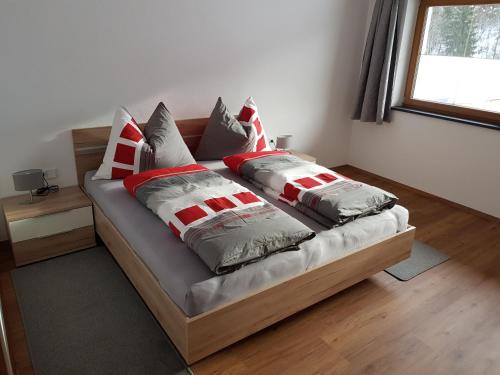 a bed with pillows on it in a room at Appartment Moser in Alpbach