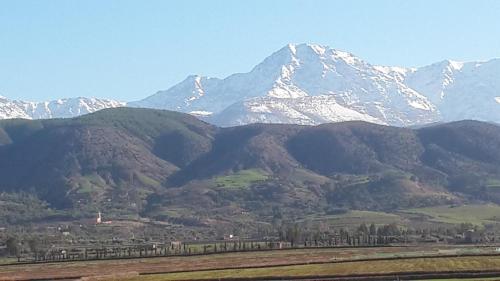 a mountain range with snow capped mountains in the background at Kasbah ATFEL in Ourika