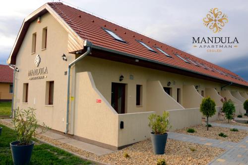 a house with a red roof at Mandula Apartman in Cegléd