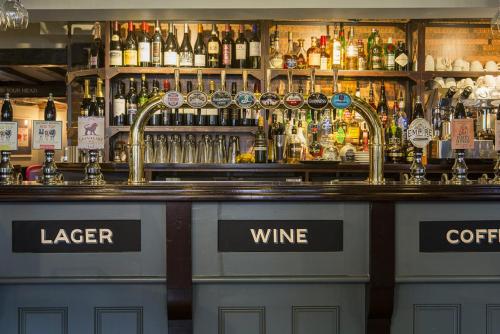 a bar with a lot of bottles of wine at The White Lion in Tenterden
