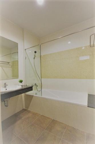 a bathroom with a shower and a sink and a shower at Paragon Suites Resort in Jomtien Beach