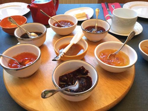 a bunch of bowls of food on a wooden plate at La Ferrade Chambres d'Hôtes B&B in Bègles
