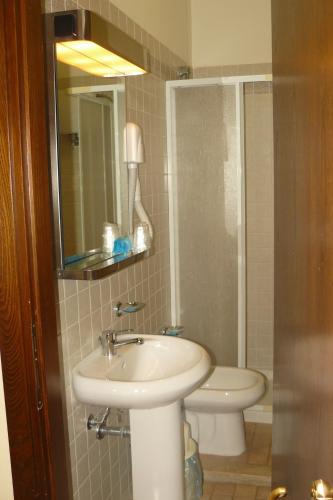 a bathroom with a sink and a toilet at Hotel La Rocca in Gubbio