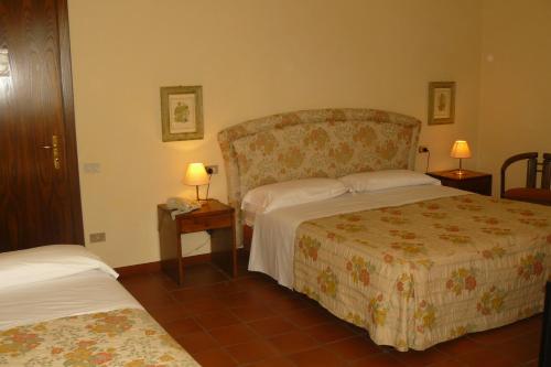 Postel nebo postele na pokoji v ubytování Hotel La Rocca