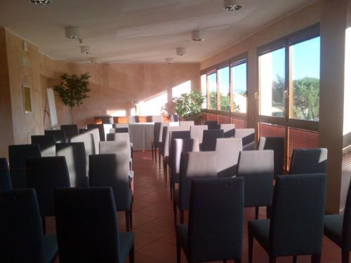 a large room filled with tables and chairs at Hotel Barberino in Barberino di Mugello