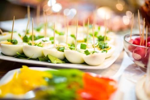 a row of appetizers on plates on a table at Apartamenty Energo in Bytom