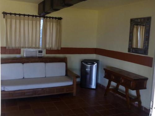 a living room with a couch and a trash can at Hotel Rancho Buenavista in Los Barriles